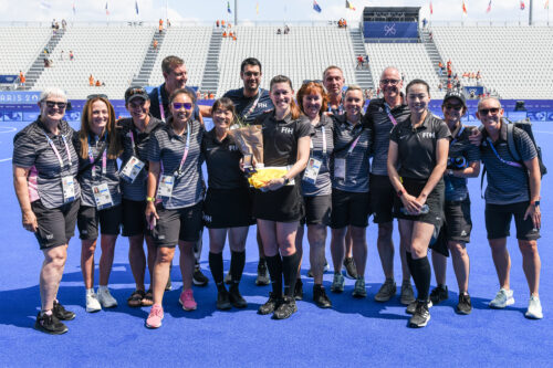 Hannah receiving her Golden Whistle, with the umpiring team.
